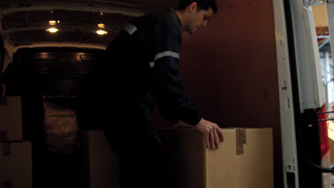 Worker-carrying-cardboard-box