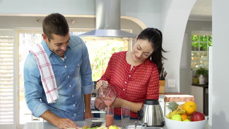 Smiling-couple-doing-smoothies