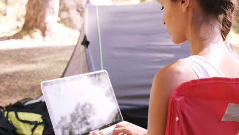 Woman-using-a-laptop-outside-the-tent