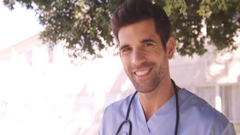 Portrait-of-male-doctor-smiling-in-the-backyard