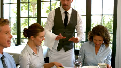 Waiter-talking-with-business-people