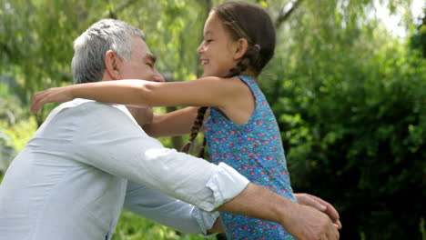 Mature-man-hugging-his-granddaughter