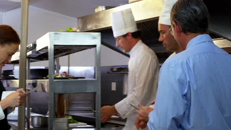 Employer-looking-at-chefs-taking-orders