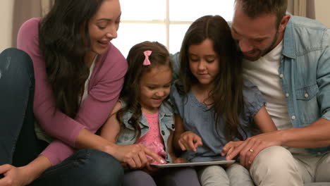 Happy-family-using-tablet-on-the-sofa