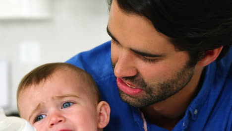 Handsome-father-feeding-his-baby