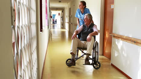 Nurse-speaking-with-his-patient-in-wheelchair