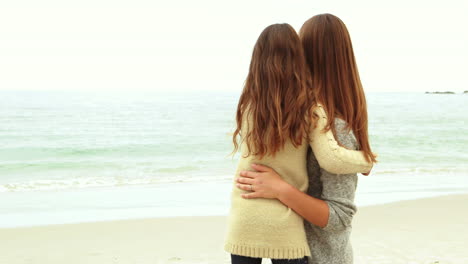 Mother-and-daughter-looking-at-beach