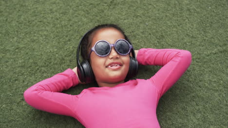 A-young-African-American-girl-is-relaxing-at-school-on-a-green-background