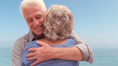 Smiling-senior-couple-hugging