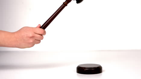 Close-up-of-hand-banging-a-law-hammer-on-the-gavel