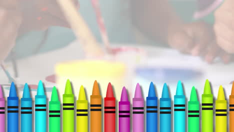 Animation-of-colored-crayons-against-mid-section-of-students-painting-at-school