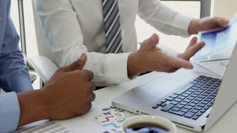 Businessman-working-together-with-a-laptop