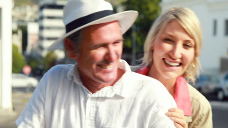 Smiling-couple-sitting-on-a-scooter