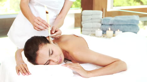 Young-woman-getting-ear-candling-treatment