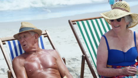 Senior-friends-sitting-in-beach-chair