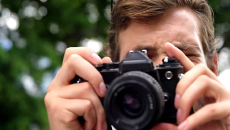 Young-man-photographing-with-a-camera
