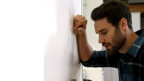 Man-is-standing-with-a-sad-expression-on-his-face