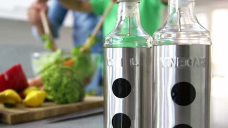 Close-up-on-bottles-in-front-of-people-cooking