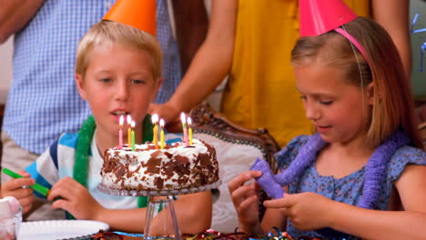 Cute-siblings-celebrating-their-birthday-with-their-family