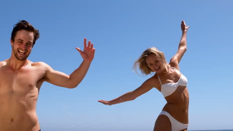 Couple-jumping-on-the-beach