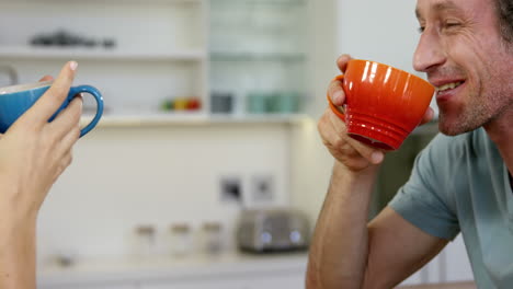 Couple-cheering-with-a-hot-beverage