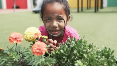 In-a-school-classroom,-a-young-biracial-girl-rests-her-chin-on-her-arms