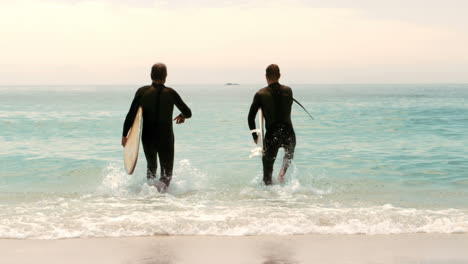Men-with-surfboards-running