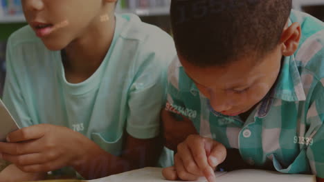 Animation-of-numbers-over-biracial-schoolboys-reading-in-class