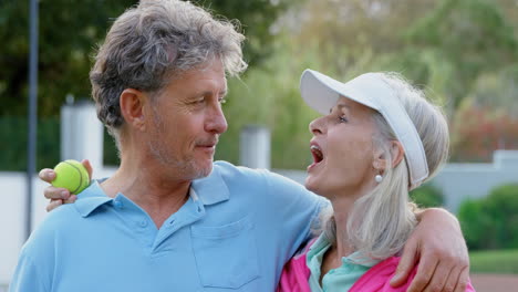 Senior-couple-talking-in-tennis-court-4k