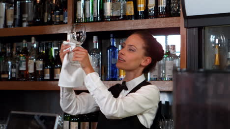 Pretty-barmaid-wiping-a-wine-glass