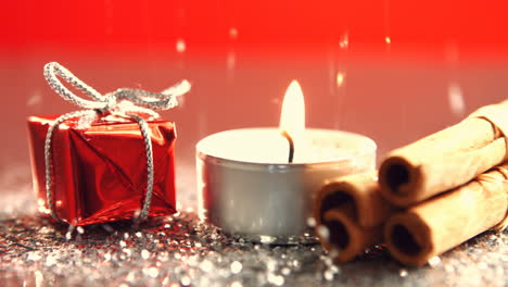 View-of-candle-burning-next-to-little-christmas-present