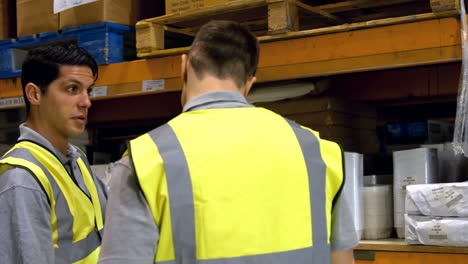 Coworkers-having-discussion-in-warehouse