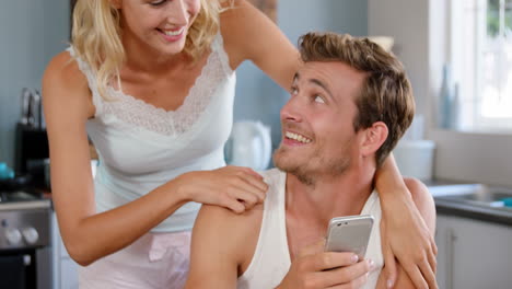 Attractive-couple-looking-at-smartphone