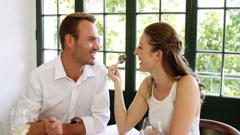 -Couple-feeding-each-other-and-smiling