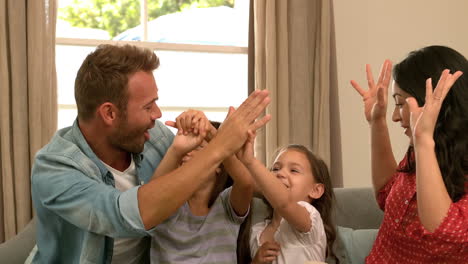 Happy-family-on-the-sofa-high-fiving