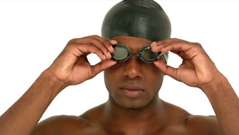 Man-putting-on-swimming-goggles
