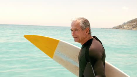 Senior-man-with-surfboard-posing