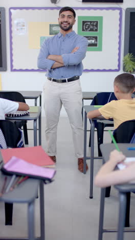 Vertical-video:-In-school,-teacher-stands-confidently-in-front-of-class