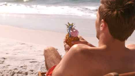 A-man-is-enjoying-with-a-pineapple-cocktail