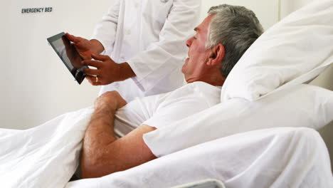 Doctor-showing-radio-with-his-tablet-to-his-patient-