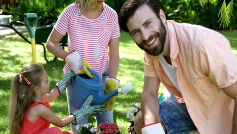 Portrait-of-father-is-smiling-in-front-of-his-family-during-the-gardening-