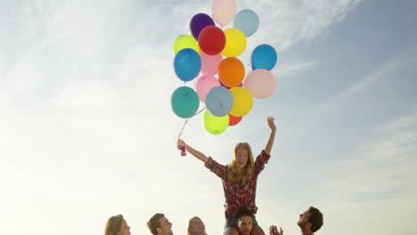 Friends-dancing-on-the-sand-with-balloon