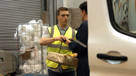 Man-delivering-courier-to-warehouse-worker