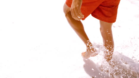 A-man-is-walking-with-his-surfboard-on-the-sea