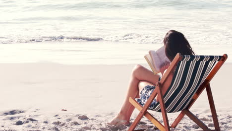 Pretty-brunette-reading-a-book-on-deck-chair