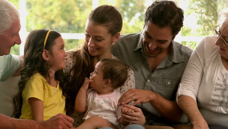 Extended-family-sitting-on-sofa