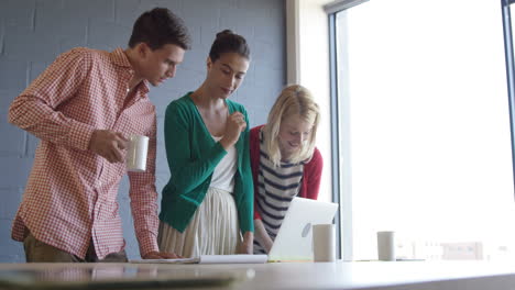 Casual-colleagues-using-a-laptop