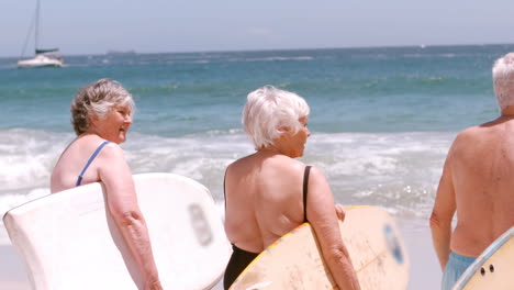 Mature-people-are-waiting-to-go-to-the-sea-with-their-surfboard