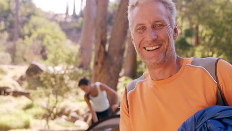 Happy-man-smiling-at-campsite