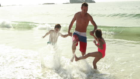 Happy-family-playing-with-waves